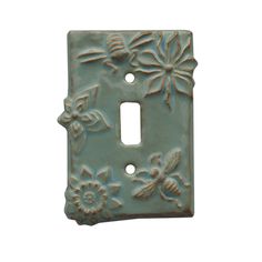 a light switch cover with flowers and bees on it's side, against a white background