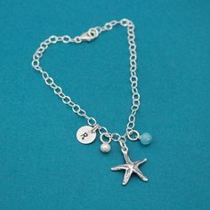 Beautiful delicate anklet with a sterling silver starfish charm. Your choice of initial and charm drops to customize to make it all your own. All dangle from 5.8mm sturdy sterling silver jump rings on a sturdy adjustable link chain with a sterling silver lobster clasp. Perfect for beach weddings! If you need extra birthstone crystals, follow this link: https://www.etsy.com/listing/113710100/one-sterling-silver-plated-flat If you would like extra tiny initials, follow this link: https://www.etsy. Adjustable Silver Charm Bracelet With Starfish, Silver Charm Bracelet With Starfish For Beach, Silver Starfish Charm Bracelet For Beach, Summer Jewelry Beach, Starfish Anklets, Birthstone Crystals, Bracelet Summer, Jewelry Beach, Beach Weddings