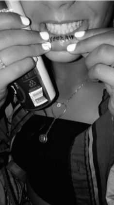 black and white photograph of a woman brushing her teeth