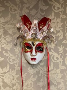 Original Venetian papier-mache mask made entirely by hand and hand-decorated with acrylic colors.It can be worn through the laces or used as a decoration of the house.Being handmade each piece is unique.All our masks are handmade by our staff (me, my wife and our collaborators) in our atelier in Venice. The masks are all made of paperweight and are made using ancient techniques from the 1300sThey are decorated with acrylic colors, gold leaf, silver leaf, trifies, lace and Swarovski crystals so a Artistic Red Masks And Prosthetics For Costume Party, Artistic Red Masks And Prosthetics For Festivals, Venetian Masks For Themed Carnival Events, Artistic Masks For Festivals And Costume Parties, Artistic Masks For Costume Party And Festivals, Artistic Red Masks And Prosthetics For Mardi Gras, Traditional Red Masks And Prosthetics For Costume Party, Artistic Red Masks For Costume Party, Artistic Red Mask For Costume Party