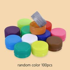 many different colors of plastic caps on a beige background with the words random color 100ps