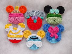 several crocheted mickey mouse and minnie mouse ear pieces are shown in different colors