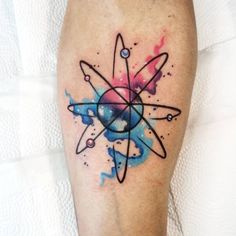 a tattoo on the leg of a person with watercolor stains and an abstract design