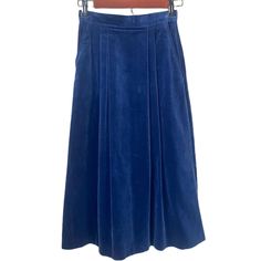 "Vintage 1970s Blue Velvet Maxi Pleated Skirt - A-Line Skirt Vintage - Size XS - 70s Vintage Skirt  Midnight blue velvet maxi A-Line skirt from the 70s. Zipper closure in the back. Two front pockets. Pleating on front and back. Some wear around zipper and back of skirt from sitting, not very noticeable with material. Maxi skirt, about mid calf length.  Marked 5-6, modern size XS Measurements: Waist 24\" Hips 34\" Length 30\"" Retro Long Blue Skirt, Retro Blue Midi Skirt, Vintage Blue Pleated Skirt, Vintage Blue Pleated Skirt Bottoms, Blue Lined Vintage Skirt, Vintage Blue Lined Skirt, Vintage Blue Flared Skirt, Retro Blue Pleated Skirt, Retro Blue Lined Skirt Bottoms