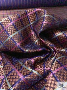 a purple and blue tie laying on top of a bed