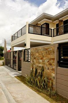 two story house with balcony and balconies on the second floor