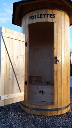 a wooden sauna with the door open to let in some hot tubs inside