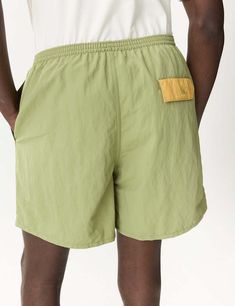 Patagonia baggies shorts (5in) in buckhorn green: these versatile shorts are perfect for land or sea with a mesh liner and quick-drying netplus® material made from recycled fishing nets helping to reduce ocean pollution.    the 5" inseam and fair trade certified™ factory make them both functional and ethical. get ready to take on the great outdoors in style!    product details —    — material: netplus® 100% postconsumer recycled nylon  — durable water repellent (dwr) finish  — recycled polyester Summer Nylon Shorts With Side Pockets, Green Nylon Bottoms With Elastic Waistband, Khaki Nylon Cargo Shorts, Green Athletic Shorts With Liner For Outdoor Activities, Green Athletic Shorts With Built-in Shorts For Outdoor Activities, Sporty Nylon Khaki Shorts, Sporty Khaki Nylon Shorts, Functional Green Nylon Bottoms, Green Nylon Athletic Shorts For Outdoor Activities