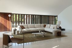 a living room filled with furniture next to a large window covered in wooden slats