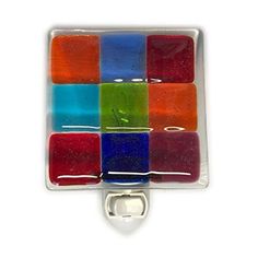 a multicolored glass bottle opener on a white background