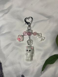 a key chain with a bear and heart charms on it