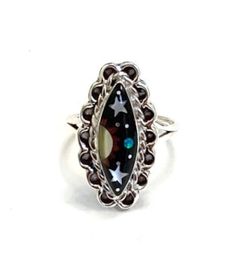 (Guaranteed 100% Sterling Silver) High quality 925 sterling silver size ring with natural genuine multicolor stones. The ring is handcrafted and the stones are inlaid together to create this beautiful Southwestern night themed piece of art jewelry. The stones consist of natural  Black Onyx, Mother of Pearl and Fire opal. The top of the ring measures 7/8'' x 1/2''. Our silver is genuine 925 sterling silver. You will receive the item in a gift box. Thanks for looking and check out more items in my Multicolor Hallmarked Jewelry Ring, Unique Multicolor Rings With Polished Finish, Sterling Silver Inlay Ring, Multicolor Polished Ring Jewelry, Multicolor Polished Finish Ring Jewelry, Unique Black Rings For Collectors, Unique Black Collectible Rings, Oval Multicolor Rings With Inlay, Unique Oval Rings With Inlay