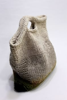 a knitted bag sitting on top of a white table