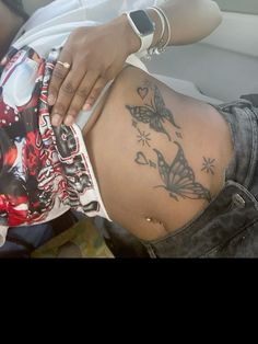 a woman with a butterfly tattoo on her stomach