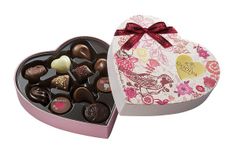 a heart shaped box filled with assorted chocolates