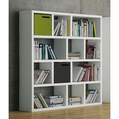 a white bookcase with many books on it