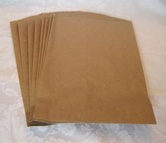 six brown paper bags sitting on top of a bed