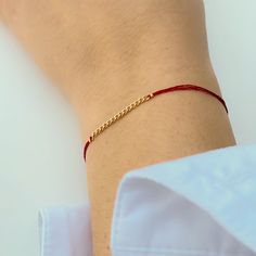 Close-up of hand wearing delicate red thread bracelet with gold chain detail at center. Red Bangle Bracelet For Everyday, Everyday Red Bangle Bracelets, Red Everyday Bangle Bracelets, Adjustable Gold Bracelet For Friendship, Trendy Red Stackable Bracelets, Threaded Bracelets, Ward Off Evil Spirits, Diy Bracelets With String, Thread Chains