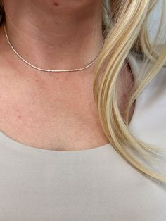 Adorn your neck with this stunning 18k Gold-filled Tennis necklace. Delicate and minimalist, its classic look is sure to make a statement. Our 1.2mm Cubic Zirconia stones shine brightly, making this the perfect accessory for any outfit. Metal: 18k Gold Filled High-quality AAAAA Cubic Zirconia Material: 1.2mm micro CZ chain Size: 12 inches long + 4 inches extender chain Hypoallergenic Water-resistant Handcrafted in Brazil Also available our matching Tennis Bracelet to complete your outfit. Fine Jewelry Tennis Necklace For Everyday, Everyday Fine Jewelry Tennis Necklace, Everyday Fine Tennis Necklace, Minimalist Diamond Tennis Necklace As Gift, Minimalist Silver Cubic Zirconia Tennis Necklace, Minimalist White Gold Diamond Cut Tennis Necklace, Classic Necklace With Delicate Chain And Cubic Zirconia, Classic Necklaces With Delicate Chain And Cubic Zirconia, Silver Minimalist Tennis Necklace For Everyday Wear