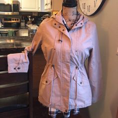 This Hooded Blush Colored Utility Style Jacket Is So Cute With Its Toggle Ties & Snaps. Wear It Loose Or Cinched At The Waist. Very Soft Cotton Washable Material. The Tag Says Size Large, But Fits More Like A Medium, Or Even A Generous Small! We Got It On An Online Boutique So Weren’t Able To Try It, And It Does Run Small. We Do Have The Tags Somewhere. Never Worn, So In Perfect Condition! Spring Fitted Hooded Jacket For Outdoors, Spring Outdoor Fitted Hooded Jacket, Fitted Hooded Jacket For Spring Outdoor Activities, Fitted Hooded Jacket For Spring Outdoor, Fitted Hooded Jacket For Spring Cold Weather, Fitted Hooded Jacket For Cold Spring Weather, Casual Spring Hooded Jacket For Cold Weather, Trendy Beige Outerwear With Drawstring Hood, Spring Parka With Drawstring Hood For Cold Weather