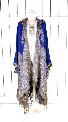 Hooded blue floral paisley pashmina kimono cover up jacket with custom length and fringe detail Measurements...taken flat - width across seam to seam: 46"  - regular length with 4" fringe: 38" (in photo) Features... - lovely soft woven medium weigh pashmina fabric - bohemian oversized flowing design - cardigan style with an open front and generous arm holes  - attached hood - universal design allows a comfortable fit for small through plus sizes -customize your length and fringe detail - the perfect layering piece that can easily be dressed up or down - wrinkle resistant  - handmade with love by me in California Blue Pashmina Shawl For Winter, Traditional Blue Shawl For Fall, Blue Bohemian Shawl For Spring, Elegant Fitted Kimono For Festival, Elegant Blue Shawl For Fall, Elegant Blue Fall Shawl, Fitted Blue Bohemian Kimono, Spring Shawl With Tassels, Blue Spring Outerwear With Tassels