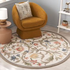 a living room with a chair, lamp and rug