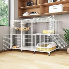 a white bird cage sitting on top of a wooden floor