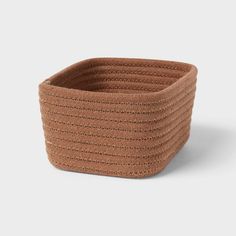 a brown woven basket on a white background