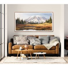 a living room with a couch, coffee table and painting on the wall above it