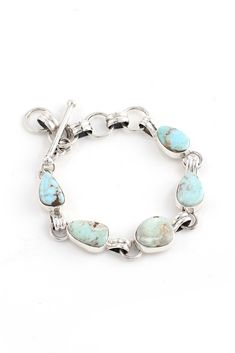 This petite Dry Creek Turquoise Link Bracelet has five individual stones bezel set and joined together with hand-crafted sterling silver links and a toggle clasp. This is a great bracelet for the smaller wrist. The Navajo artist, Leonard Paquin chose lovely stones for this piece. The adjustable chain makes this bracelet very comfortable to wear. Dry Creek Turquoise, from Northern Nevada, is a very unusual pastel turquoise with light brown matrix. Every part of this bracelet was handmade. Dry Cre Northern Nevada, Dry Creek, Silver Eagles, Toggle Clasp, Bezel Setting, Silver Bracelets, Link Bracelets, Turquoise Bracelet, Fashion Jewelry