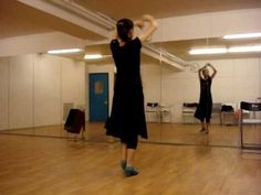 two women are dancing in an empty room