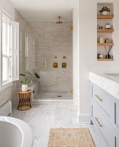 a bath room with a tub a sink and a window