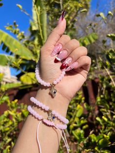 pink beaded protection adjustable bracelets with gold accents and cross charm. ✨ Pink Adjustable Rosary Bracelet For Friendship, Adjustable Pink Rosary Bracelet For Friendship, Adjustable Handmade Pink Rosary Bracelet, Pink Adjustable Spiritual Friendship Bracelets, Adjustable Pink Spiritual Friendship Bracelets, Spiritual Pink Round Beads Friendship Bracelets, Spiritual Pink Friendship Bracelets With Round Beads, Pink Spiritual Charm Bracelet For Friendship, Pink Spiritual Bracelets For Friendship