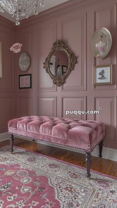 a pink bench sitting in the middle of a living room next to a chandelier