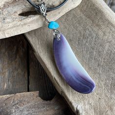 Long wampum necklace, Buzzards bay native wampum Pendant accented with turquoise Magnesite. Locally found, polished and designed by me, S. Amaral. Affordable Cape Cod wampum Jewelry Your will enjoy wearing one of this beautiful wampum pendants.  The genuine handpicked wampum shell represents energy from the ocean and the turquoise Magnesite is a wonderful relaxing and calming stone used in meditation with the potential to aid you make astounding changes in your life.  I designed this piece to pop against anything that you wear. The pendant hangs from a 20" smooth black cord.  My Wampum is highly polished to give it a lasting luster.  One of a kind. Each piece I make is unique in its own way and is a one of a-kind.  Gift Boxed. History Certificate included.  My family tree dates back to the Purple Southwestern Jewelry For Gifts, Southwestern Style Purple Jewelry For Gift, Purple Southwestern Jewelry For Gift, Purple Southwestern Style Jewelry For Gift, Bohemian Purple Necklace With Large Pendant, Wampum Necklace, My Family Tree, Native American Ancestry, Buzzards Bay