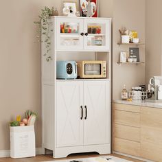 a kitchen with a white cabinet next to a counter top and a microwave on it