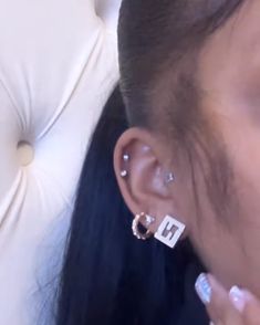 a close up of a person with ear piercings on their ears and one behind the ear