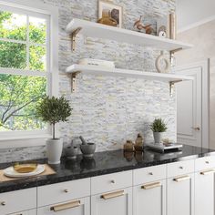 a kitchen with white cabinets, black counter tops and gold trim on the shelves is shown