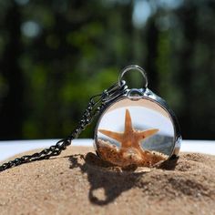 Round pendant with starfish, shells and sand encased in glass creating a shaker necklace. Made in USA Ocean-inspired Glass Necklaces For Gifts, Moving Jewelry, Sand Jewelry, Best Teacher Gifts, Teacher Mom, Moon Pendant Necklace, Figaro Chains, Figaro Chain, Gift For Teacher