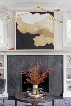 a living room filled with furniture and a painting on the wall above a fire place