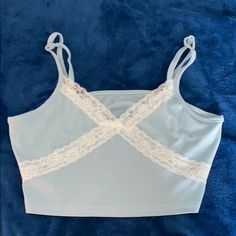 It’s A Size Small But Can Also Fit A Medium. Super Pretty Blue Color W Lace Details. Never Worn Before. No Tags. Casual Blue Cami Crop Top, Blue Cami Crop Top For Spring, Light Blue Cami Crop Top For Spring, Blue Lace Top, Blue Lace, Lace Detail, Lace Top, Blue Color, Womens Tops