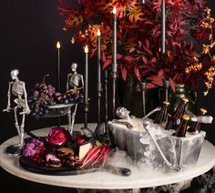 skeleton figurines and wine bottles on a table