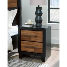 a night stand with two drawers and a lamp on the end table next to it