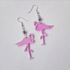 Pink Flamingo acrylic earrings A quirly kitsch style pair of earrings with a pink acrylic 3 cm Flamingos Hung from either a silver plated or sterling silver earring hook. Finished with a silver bead. Drop length: 1.5 inches All components are allergy and nickel free. Hand made in Britain. Pink Novelty Earrings For Party, Pink Novelty Dangle Jewelry, Quirky Pink Earrings, Fun Pink Dangle Jewelry, Pink Fun Dangle Jewelry, Novelty Pink Earrings For Summer, Nickel-free Pink Novelty Earrings, Novelty Pink Nickel-free Earrings, Pink Whimsical Pierced Earrings