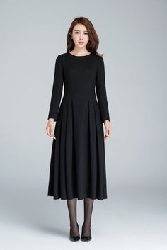 "This Long black dress design with midi length, match a black heel, make you more slim and high. This wool dress design with a smaller collar, so it open by back zipper, so that your head can through easily. This winter dress is warm in cold winter. it has a polyester lining, so don't need worry not comfortable. Details: * Made from black wool * 35% wool blend, 35% fiber and polyester, 30% nylon * Polyester lining * Big Round neckline * No pockets * Back zip closure * Long sleeve * Below the kne Wool Dress Winter, Old Fashion Dresses, Dress Winter, Dress Pleated, Jumpsuit Elegant, Handmade Dress, Ladies Dresses, Dressed To The Nines, Dress Handmade