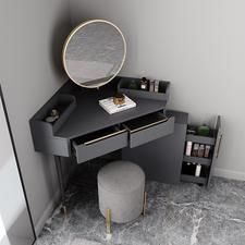 a vanity with a mirror, stool and other items on the floor in a bathroom