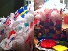 there are many different colored plates and decorations on the table with flags in them,