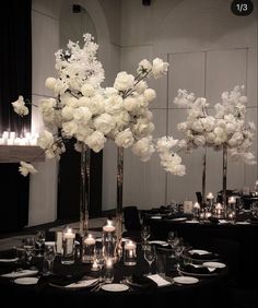 the centerpieces are all white flowers and candles