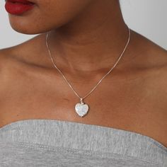 An iridescent and creamy necklace, which will enhance any outfit while giving an elegant and confident vibe. This necklace contains a heart-shaped pearl pendant, which is held by three small sterling silver delicate rings. Delicate White Heart Pendant Jewelry, Sterling Silver Heart Pendant Jewelry With Heart Beads, Sterling Silver Heart Pendant With Heart Beads, Elegant Silver Heart Necklace With Heart Beads, White Heart Necklace For Wedding, Mother's Day Pearl White Sterling Silver Jewelry, White Sterling Silver Necklace With Heart Charm, White Jewelry With Heart Charm Round Pendant, White Jewelry With Round Pendant Heart Charm