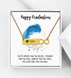 a card with a gold bar that says, happy graduation you're braver than you believe, stronger than you think, and loved more than you know